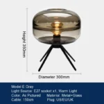 Modern table lamp with glass shade on bedside table
