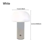 Modern mushroom table lamp with warm glow on wooden table