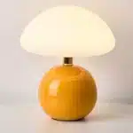 Mushroom table lamp with cream ceramic shade on bedside table