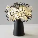 Modern table lamp with PVC flower design in a cozy bedroom setting