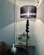 Modern crystal floor lamp with black finish and LED light in a living room