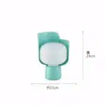 Rotating petal desk lamp with adjustable petals in pastel colors on a bedside table