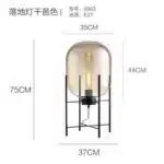 Modern floor lamp with iron frame and glass shade in a cozy living room