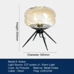 Modern table lamp with glass shade on bedside table