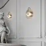 Modern wall lamp with minimalist Nordic design illuminating a cozy bedroom bedside