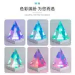 3D pyramid night light with RGB color modes on a bedside table