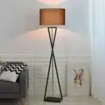 Modern floor lamp with iron frame and fabric shade in a contemporary living room
