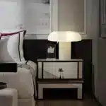 Elegant marble table lamp with soft glow on bedside table in bedroom
