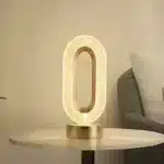 Elegant oval crystal table lamp with USB charging on a bedside table