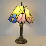 Vintage table lamp with handmade colored glass shade casting warm ambient light
