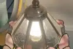 Vintage desk lamp with stained glass butterfly shade casting warm glow on bedside table