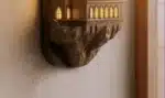 Castle wall lamp illuminating a cozy bedroom corner with warm light