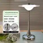 Goldoma rechargeable table lamp with flying saucer shape and warm glow on a bedside table