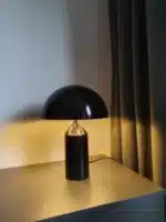 Modern mushroom table lamp with metal shade and wood base on bedside table