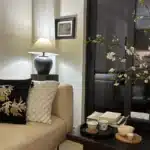 Wabi sabi table lamp with textured ceramic base and linen shade in a cozy living room