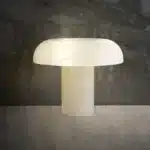 Elegant marble table lamp with soft glow on bedside table in bedroom
