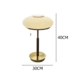 White glass table lamp with vintage design on a wooden desk in a cozy bedroom