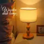 Vintage table lamp with fabric shade and solid wood base on bedside table