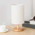 Modern linen table lamp with USB port and touch control on bedside table