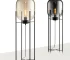 Modern floor lamp with iron frame and glass shade in a cozy living room