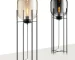 Modern floor lamp with iron frame and glass shade in a cozy living room