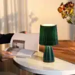 Milkshake bedside table lamp with warm LED light on a nightstand in a cozy bedroom