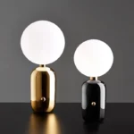 Modern table lamp with glass shade on bedside table