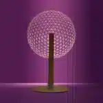 3D LED table lamp with wooden base and acrylic art glowing in a cozy room