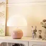 Mushroom table lamp with cream ceramic shade on bedside table