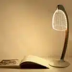 3D LED table lamp with wooden base and acrylic art glowing in a cozy room