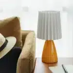 Milkshake bedside table lamp with warm LED light on a nightstand in a cozy bedroom