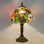 Vintage table lamp with handmade colored glass shade casting warm ambient light