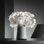 Modern table lamp with PVC flower design in a cozy bedroom setting