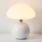Mushroom table lamp with cream ceramic shade on bedside table