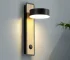 Modern wall sconce bedside lamp with rotating arm in a cozy bedroom setting
