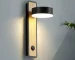 Modern wall sconce bedside lamp with rotating arm in a cozy bedroom setting