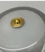 Modern bedside lamp with cream glass shade on a nightstand