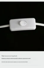 Warm night light pebble LED lamp glowing on a bedside table