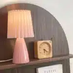 Milkshake bedside table lamp with warm LED light on a nightstand in a cozy bedroom