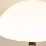 Mushroom table lamp with cream ceramic shade on bedside table