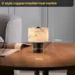Elegant marble table lamp with soft glow on bedside table in bedroom