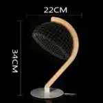 3D LED table lamp with wooden base and acrylic art glowing in a cozy room