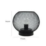 Decorative bird cage lamp with warm LED light, iron frame, and silk screen details on a bedside table
