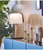 Modern bedside lamp with cream glass shade on a nightstand