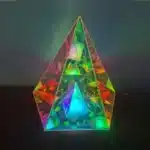 3D pyramid night light with RGB color modes on a bedside table