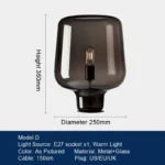 Modern table lamp with glass shade on bedside table