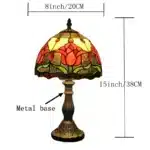 Tiffany table lamp with tulip stained glass shade, rustic bronze base, glowing warmly