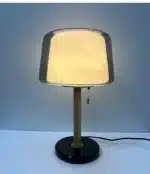 Modern bedside lamp with cream glass shade on a nightstand