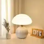 Mushroom table lamp with cream ceramic shade on bedside table