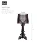 White ghost table lamp with transparent baroque design on a bedside table in a modern bedroom